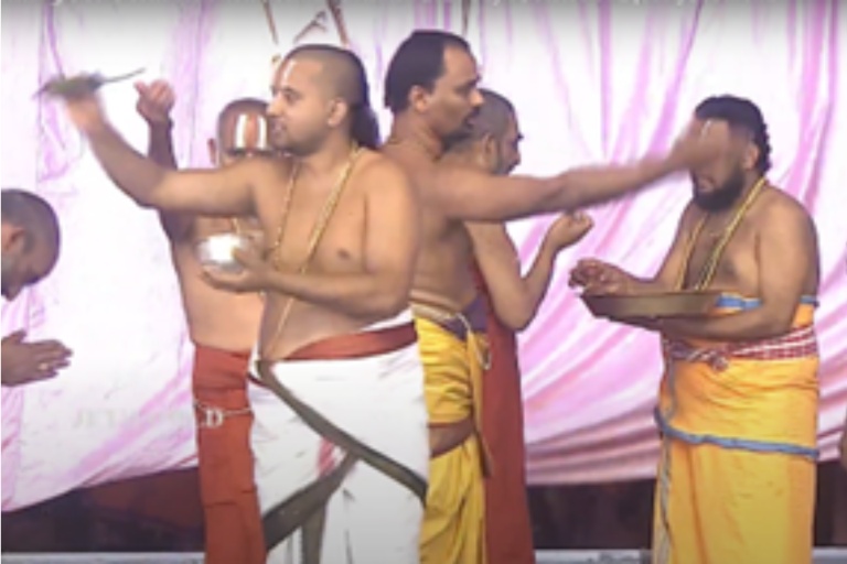 Abhisheka theertham being sprinkled on devotees